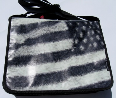A recycled laptop bag made out of Powershop's Electricity vs Power billboard campaign